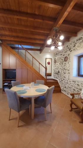 a dining room with a table and chairs at Filanthi's Retreat In Mani's Nature in Krini Peloponnese