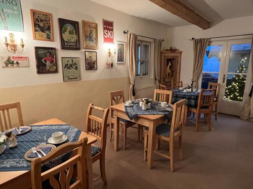 a dining room with tables and chairs and a christmas tree at Koller, Pension Haus in Kitzbühel