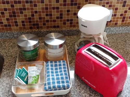 a red toaster sitting next to a mixer on a counter at Casas con vista al Piltri in El Bolsón