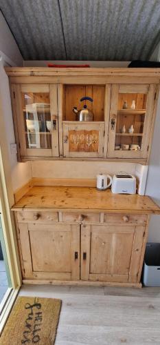 a wooden cabinet with a pot on top of it at Park Farm Holidays Glamping in Lyndhurst