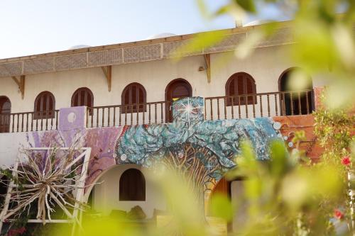 a building with a mural on the side of it at Nook seaview in Dahab