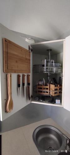 une cuisine avec un évier et un comptoir avec des ustensiles dans l'établissement Le VIP cabourg,200m de la plage et de la promenade Marcel Proust,600m du centre, agréable F2 en rez de jardin, à Cabourg