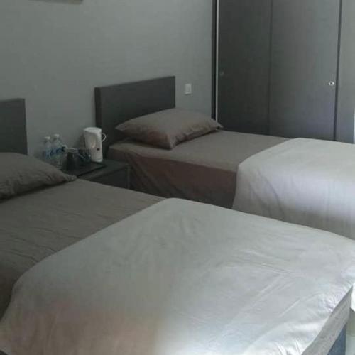 two beds in a room with at Blackstone Beach Resort in Kuantan