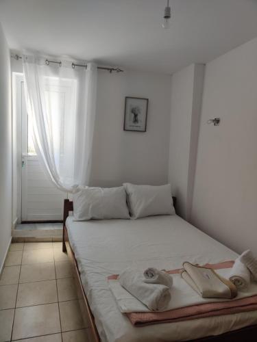 a bedroom with a bed with towels on it at CORFU FOTIS house in Neochorákion