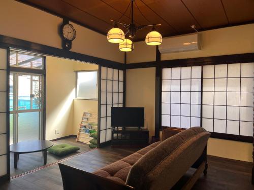 een woonkamer met een bank en een tv bij 水龍Suiryu in Fujisawa