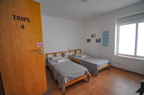 a hospital room with two beds and a door at Surf Vibe Guest House in Faro