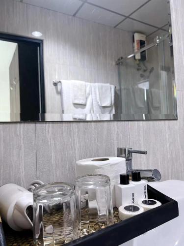a bathroom with a sink and a mirror at Tongyang House Serviced Apartment in Bangkok