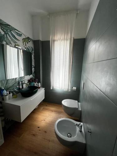 a bathroom with a sink and a toilet and a mirror at Villa Sissi in Bari