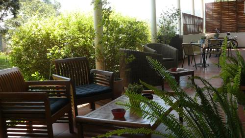a patio with chairs and a table and plants at B&B Inés in Sant Cugat del Vallès