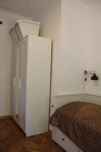 a bedroom with a bed and a white refrigerator at Villa Hedonic in Ulcinj