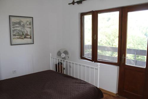 a bedroom with a bed and a window at Villa Hedonic in Ulcinj