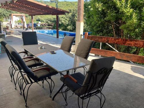 a table and chairs on a patio next to a pool at Villa Hedonic in Ulcinj