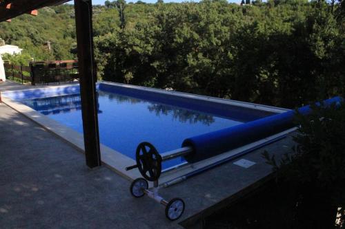 a pool with a blue pipe next to a swimming pool at Villa Hedonic in Ulcinj