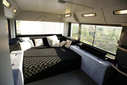 a bedroom with a bed in the back of an rv at Boutique Bus close to Tel Aviv and BG Airport, 