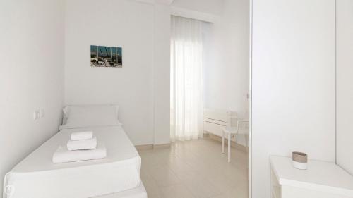 Ένα ή περισσότερα κρεβάτια σε δωμάτιο στο Rivazzurra Homes - C