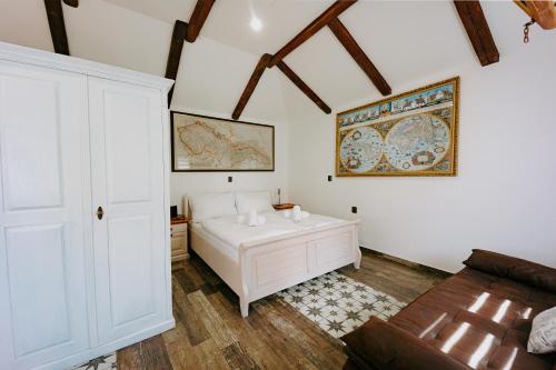 a white room with a bed and a couch at Villa Libosad in Jičín