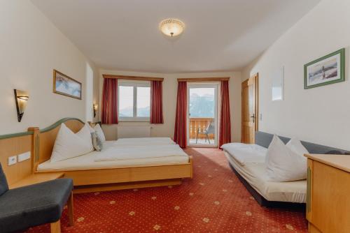 a hotel room with a bed and a couch at Apparthaus Taxegger in Haus im Ennstal