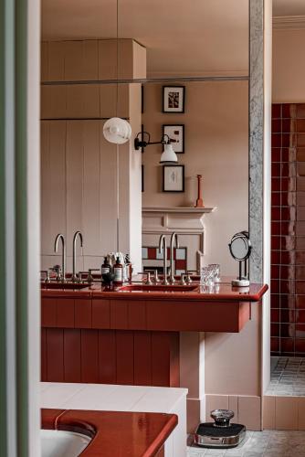 a kitchen with two sinks and a tub at Cowley Manor Experimental in Cheltenham