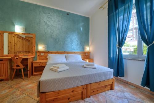 a bedroom with a bed with two towels on it at Camere da Mirella in Lazise