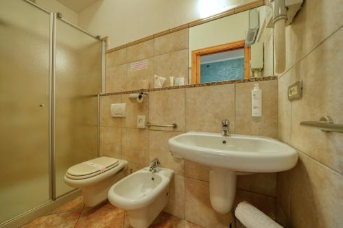 a bathroom with a sink and a toilet at Camere da Mirella in Lazise
