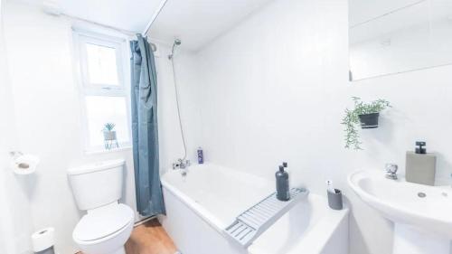 a white bathroom with a toilet and a sink at Spacious 2 Bedroom Apartment in Barrow in Furness