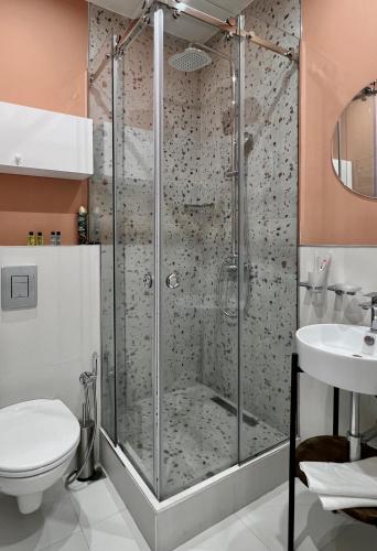 a bathroom with a shower with a toilet and a sink at Sweet Home Apart-Hotel in Yerevan