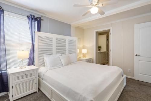 a bedroom with a white bed and a ceiling fan at Casa Isabelle by Brightwild in Key West
