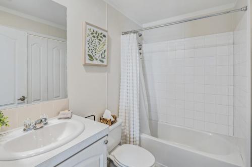 a white bathroom with a sink and a toilet at Casa Isabelle by Brightwild in Key West