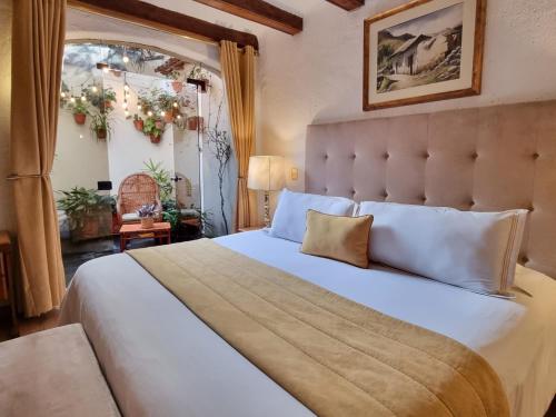 a bedroom with a large bed with a large window at Antara Hotel & Suites - Miraflores in Lima