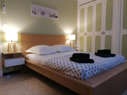 a bedroom with a large bed with two pillows on it at Aux portes de la Camargue in Jonquières-et-Saint-Vincent
