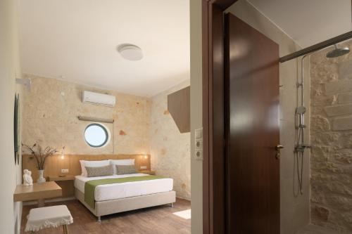 a bedroom with a bed and a walk in shower at Mouria Country House in Gállos