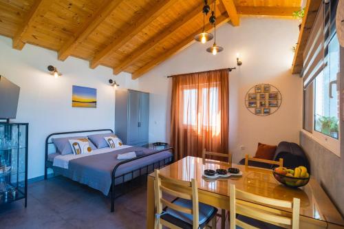 Studio apartman Mediteran في مارينا: غرفة نوم مع سرير وغرفة طعام مع طاولة