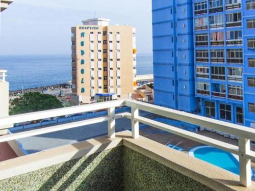 a balcony with a view of the ocean and buildings at Live Candelaria Alsaca con Balcón y Vista al Mar in Candelaria