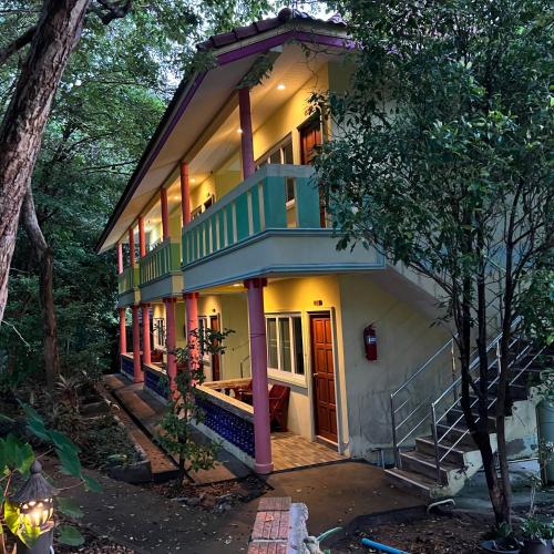 a house with a green and white at Oceanview Bungalows by EAT in Karon Beach