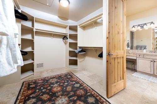 a walk in closet with a large rug on the floor at Palatial Paradise with Breathtaking Views of Red Rock and Stunning Infinity Pool in Sedona