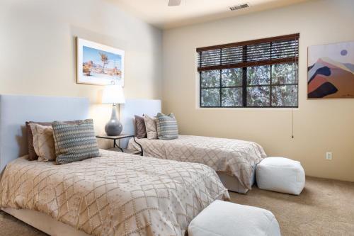 a bedroom with two beds and a window at Palatial Paradise with Breathtaking Views of Red Rock and Stunning Infinity Pool in Sedona
