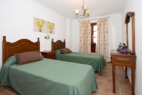 a bedroom with two beds and a mirror at Apartment Limonade Deluxe Main Center Playa Blanca By PVL in Playa Blanca