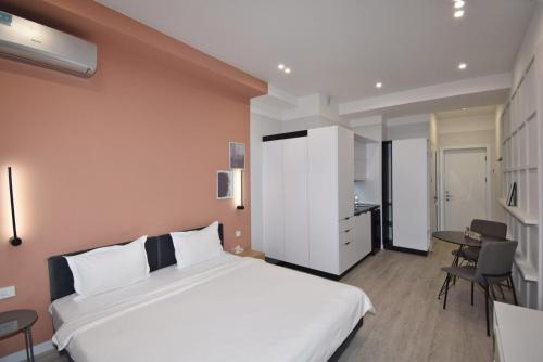 a bedroom with a large white bed and a desk at Sweet Home Apart-Hotel in Yerevan