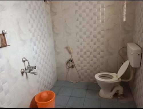 a bathroom with a toilet and a shower at Tulips near SNS eng college, mullai hall in Pīlamedu