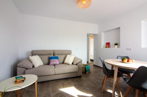 a living room with a couch and a table at Edificio Manuel de Falla Apartamentos in Barbate