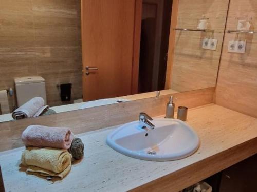 a bathroom counter with a sink and a mirror at Homing Sabadell 73 in Sabadell