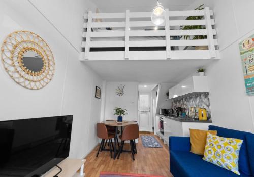 a living room with a blue couch and a table at One-of-a-Kind Stay Free Parking in Brighton & Hove