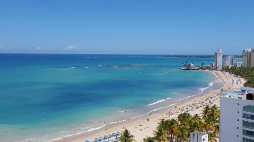 a view of a beach with people and the ocean at 2BR Condo at Isla Verde Beach in San Juan
