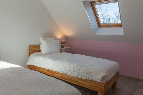a bedroom with two beds and a window at Le Cissereau - Chambres et table d'hôtes in Onzain