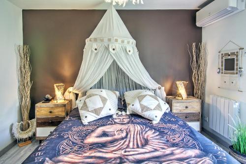 a bedroom with a bed with a painting on it at O jardin des Sens -Séjour Bien-être & détente &Jacuzzi in Béziers