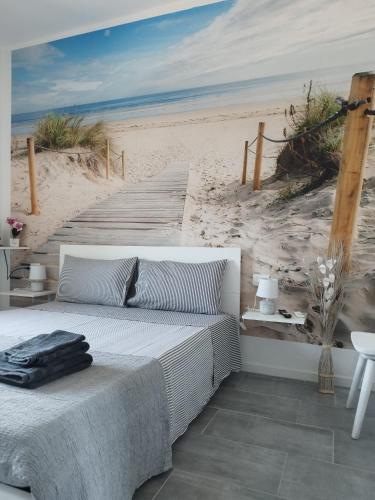 a bedroom with a bed and a beach mural at b&b Casa Balai 72 a 100 mt dal mare in Porto Torres