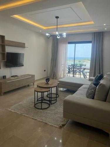 a living room with a couch and a table at Residence prestige in Nabeul