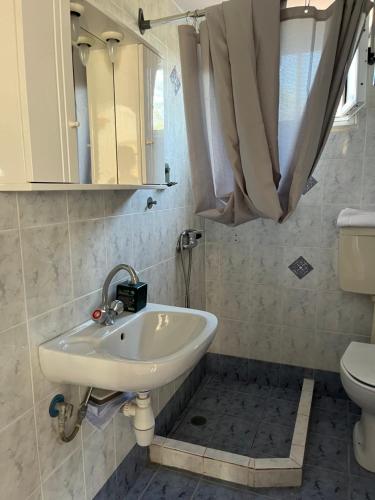 a bathroom with a sink and a toilet at Harry's House in Elafonisos