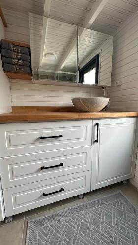 a white kitchen with a counter and a mirror at ELIES TINY GLAMPING in Ayvalık