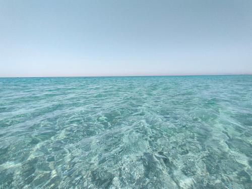 a large body of water with a clear blue sky at Suite12 in Marsala